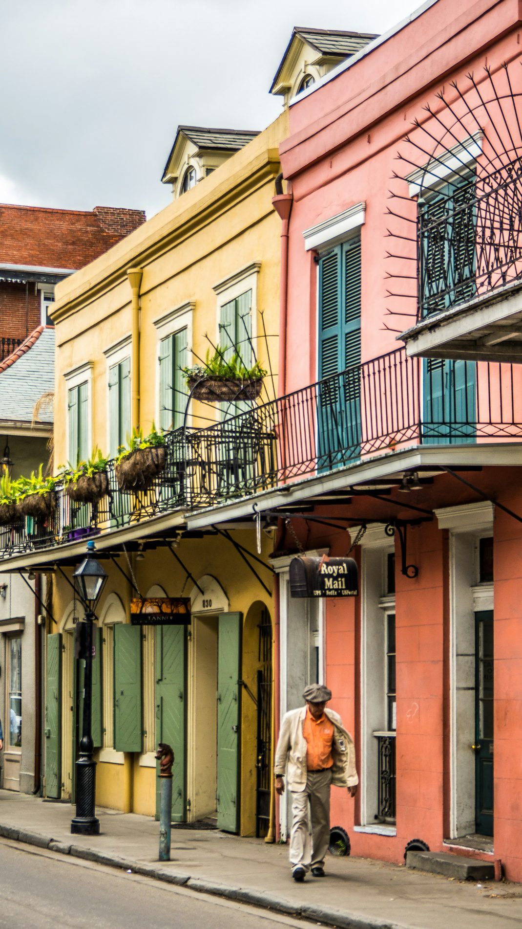 Colorful historic balconied buildings on a French Quarter street in New Orleans